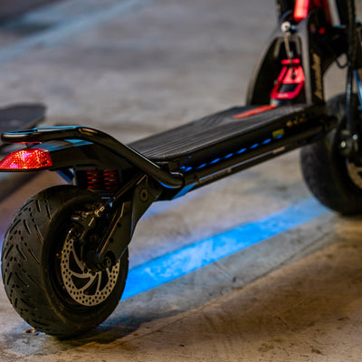 Kaabo Warrior 11 electric scooter showcasing under-deck LED lighting and robust dual-wheel design for night riding.