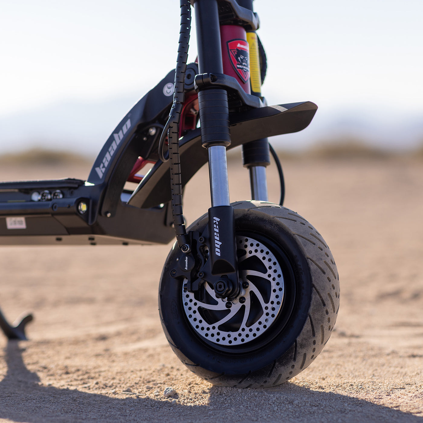 Detailed view of the Kaabo Warrior 11 Pro+ showcasing the hydraulic dual suspension system for superior ride comfort and handling on various terrains.