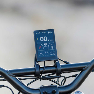 Close-up view of the Kaabo Wolf King GTR electric scooter's TFT display showing speed, battery level, and other ride metrics.